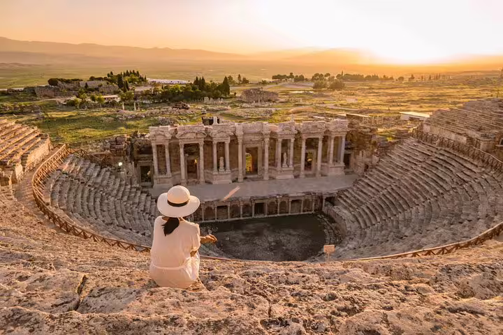 Traveler enjoys sunset view at the ancient Roman theater in Hierapolis during Pamukkale day tour from Istanbul.