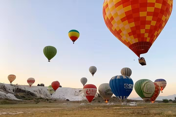 Colorful hot air balloons at sunrise over Pamukkale travertines, Turkey, on scenic balloon flight tour