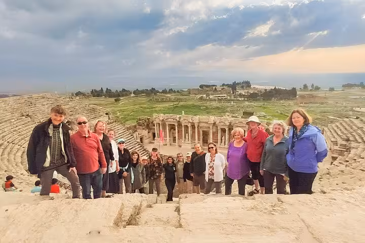 Group photo at Hierapolis amphitheater on a private Pamukkale tour with Denizli Airport pickup