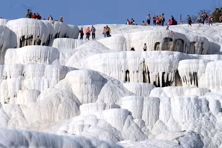 Crowds walking on Pamukkale travertine terraces during a private tour from Denizli Airport, Turkey