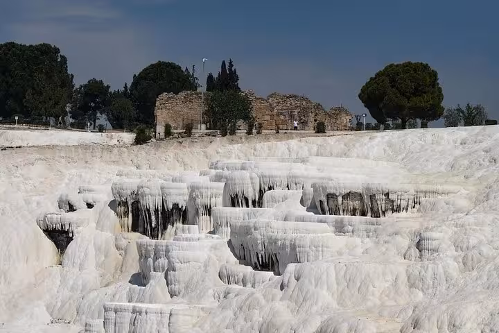 White Pamukkale travertine terraces with Hierapolis ruins, private tour transfer from Denizli Airport