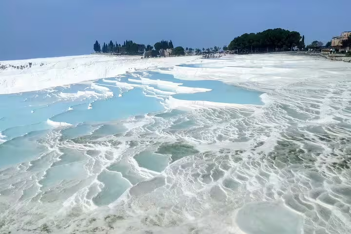 Pamukkale white travertine terraces and turquoise thermal pools on a 2-day mini group tour from Kusadasi
