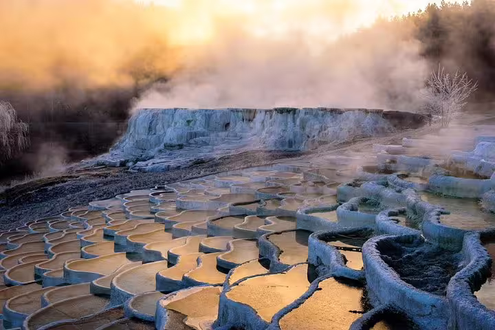 Sunrise over Pamukkale travertine terraces with steaming thermal pools, highlight of a private tour in Turkey