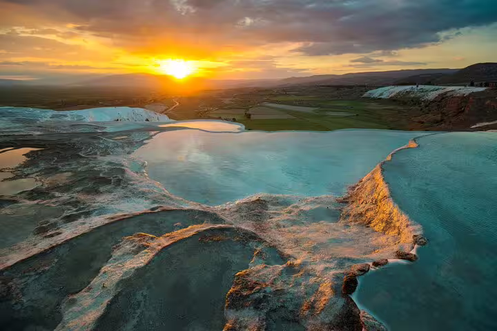 Pamukkale's travertine terraces at sunset during a 2-day tour from Istanbul.