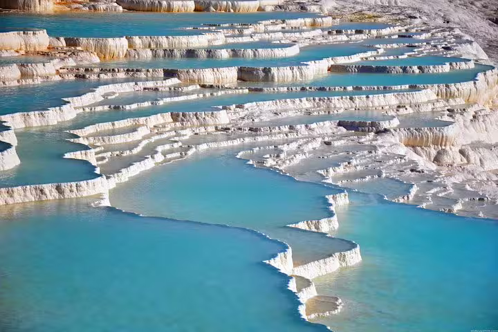 Pamukkale travertine terraces with turquoise thermal pools, highlight of Pamukkale tour from Pamukkale
