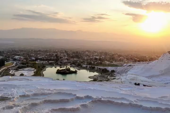 Sunset over Pamukkale white travertine terraces and thermal pools, highlight of 8-day Turkey flight tour