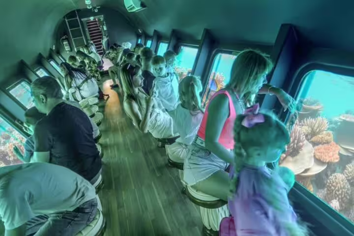Inside Hurghada semi-submarine viewing coral reefs through underwater windows on Panorama snorkeling sea excursion