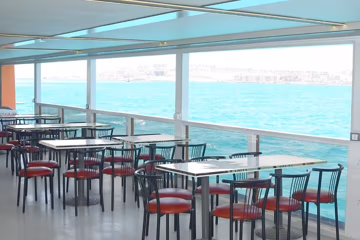 Panorama semi-submarine Hurghada lounge with sea-view windows and tables, cruising the Red Sea before snorkeling