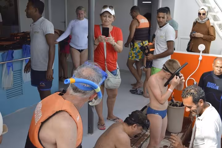 Guests gearing up with snorkel masks on Panorama semi-submarine deck in Hurghada Red Sea snorkeling tour