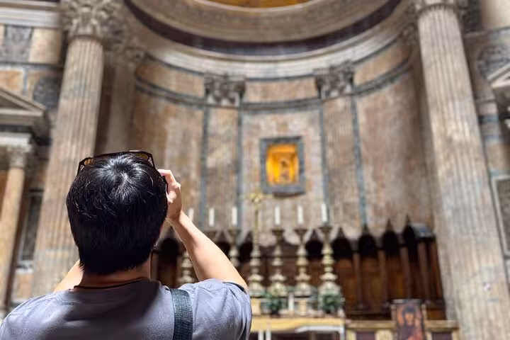 Visitor photographing the ornate altar inside the Pantheon Rome during a skip-the-line tour.