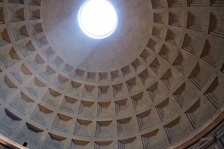 View of the iconic oculus and coffered dome of the Pantheon in Rome, a masterpiece of ancient architecture.