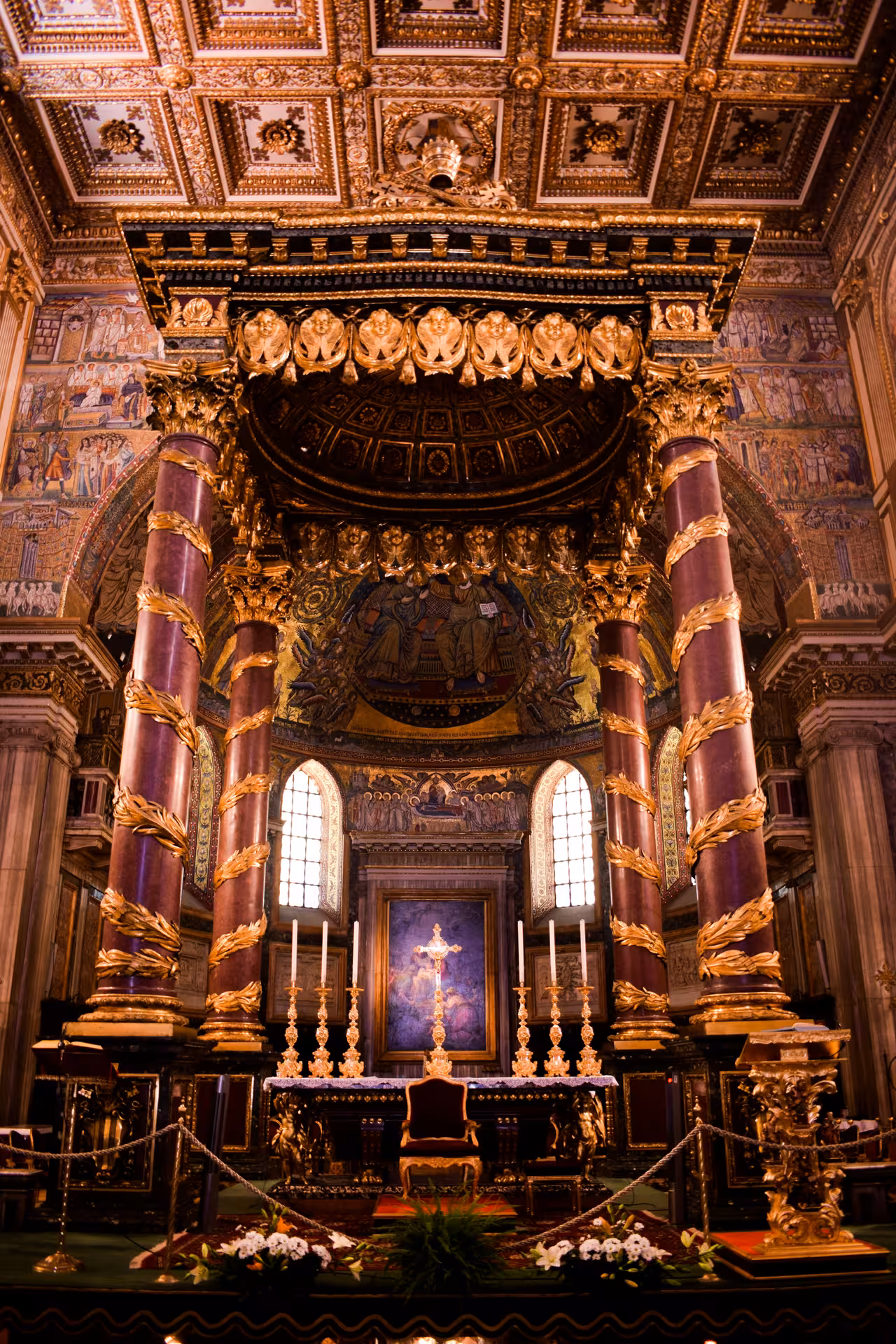 Intricate interior of Papal Basilica with ornate columns and golden decorations in Rome, ideal for cultural tours.