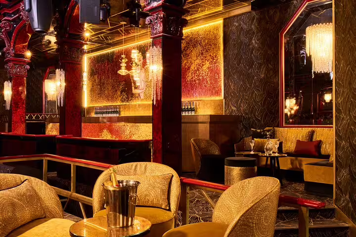 Opulent gold and red interior of Paradis Latin cabaret with velvet chairs and crystal chandeliers in Paris