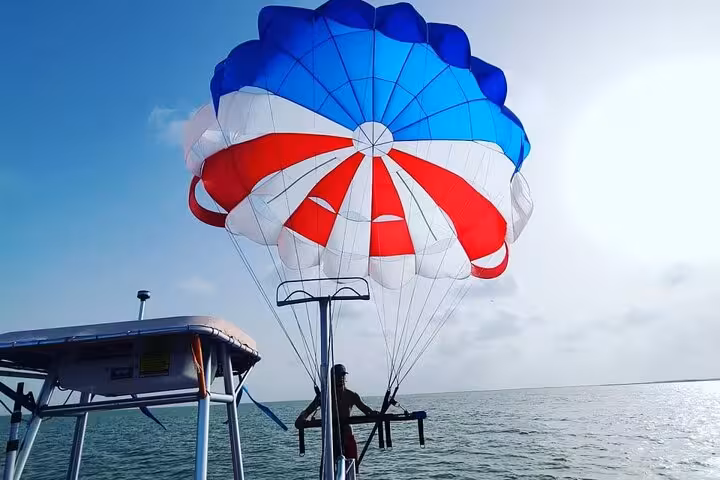 Parasailing boat launch in Sharm El Sheikh on the Red Sea, red white blue canopy ready for flight with transfer