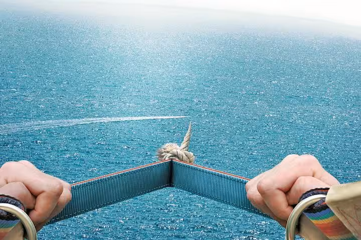Parasailing harness view above turquoise Red Sea from Hurghada, soaring toward Sahl Hasheesh and Soma Bay
