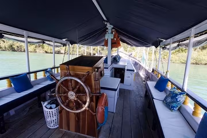 Spacious boat interior with seating and steering wheel, perfect for a comfortable Paraty tour with lunch on board.