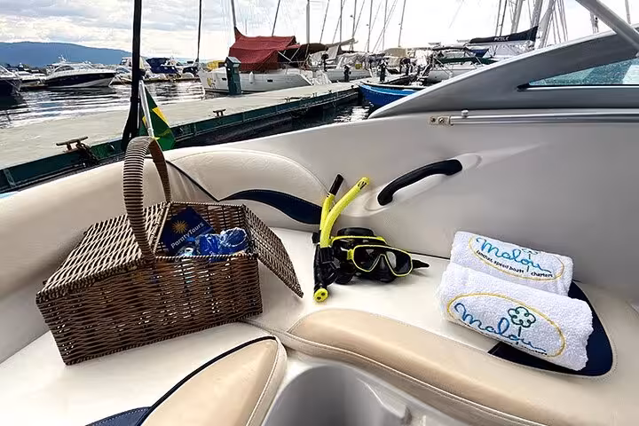 Snorkeling gear and picnic basket on boat deck ready for Paraty's scenic and adventurous boat tour.