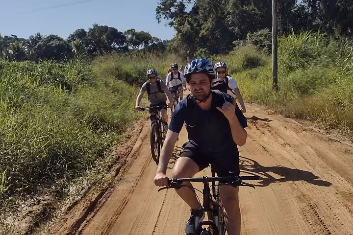 Group of cyclists exploring lush trails on a guided bike tour in Paraty, enjoying the natural surroundings.