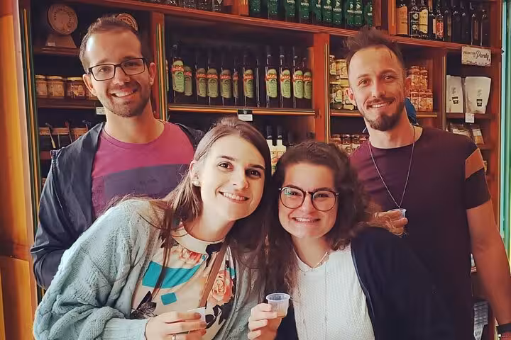 Group enjoying cachaça tasting at a traditional shop on the Paraty historical tour.