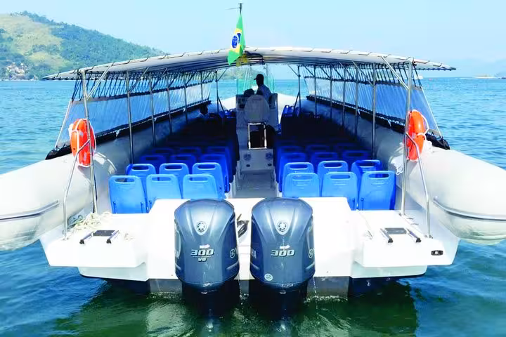 Spacious boat with powerful engines ready for shared transfer from Paraty to Ilha Grande, offering scenic views.