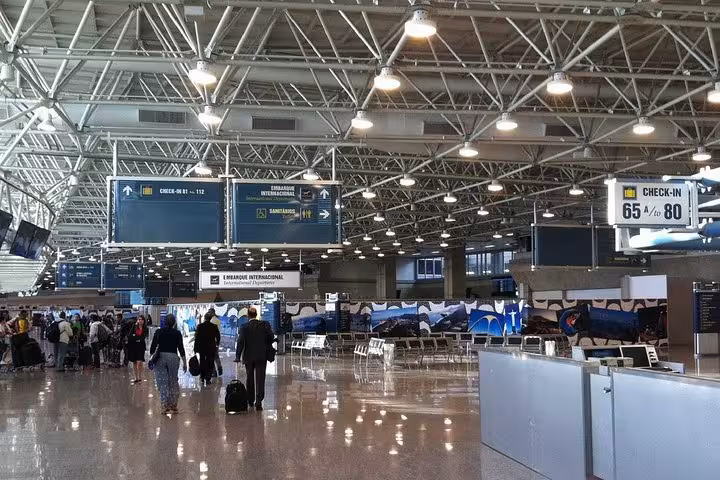 Spacious terminal at Rio de Janeiro airport bustling with travelers, ideal for arrivals from Paraty shared transfers.