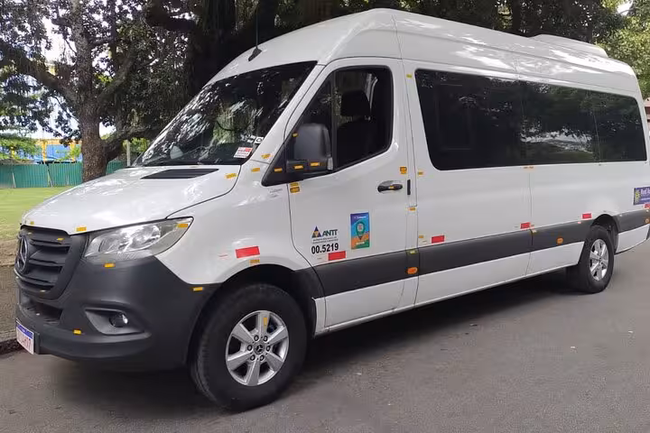Comfortable white tour van ready for shared transfer from Paraty to Rio de Janeiro hotels, ensuring a smooth journey.