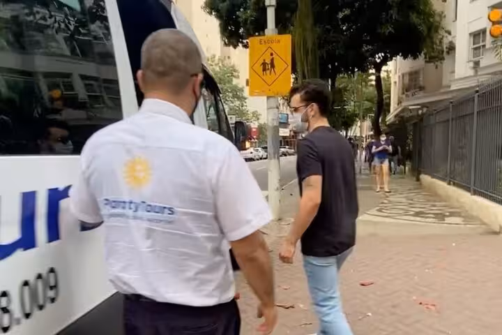 Passenger boarding Paraty Tours shuttle in São Paulo, highlighting convenient shared transfer service from Paraty.