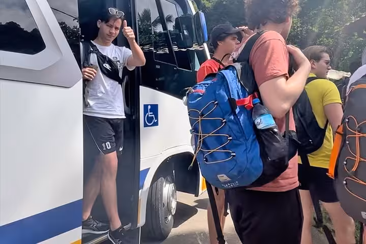 Tourist entering Paraty Tours van for shared transfer to Rio de Janeiro, emphasizing ease and accessibility of service.