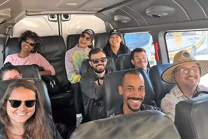 Happy travelers enjoying a comfortable shared transfer from Paraty to hotels in Rio de Janeiro, capturing joyful moments.