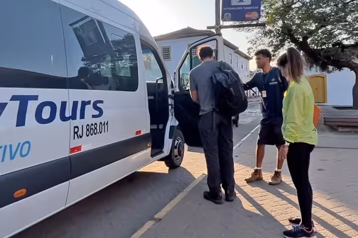 Travelers boarding a tour van in Paraty, preparing for a shared transfer to the scenic destination of Ilha Grande.