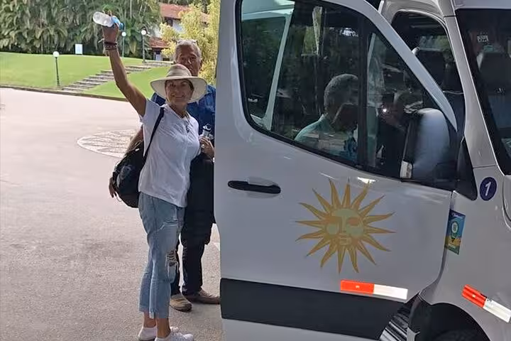 Tourists boarding a shuttle for a shared transfer from Paraty to Rio de Janeiro hotels, ready for a seamless journey.