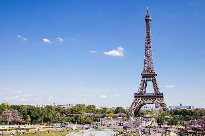 Eiffel Tower view in a sunny Paris, highlighting a perfect stop for travelers on a Paris airport layover tour experience.