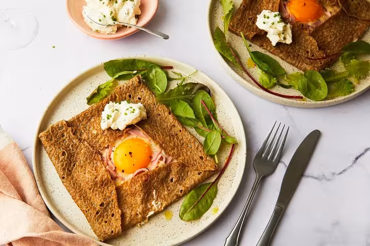 Savoury buckwheat galette topped with egg and cheese, a highlight of the Paris flavors tour in Le Marais.
