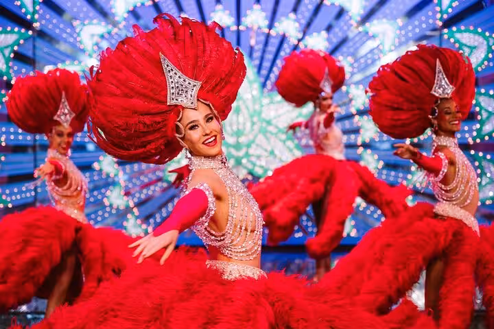 Paris cabaret show dancers in red feather costumes, Montmartre dinner and show semi-private experience