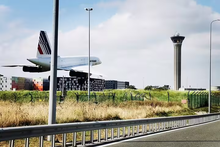 Plane near Paris Charles de Gaulle airport control tower, private roundtrip transfer for 1-3 people