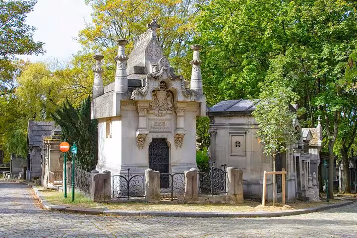 Historic Paris cemetery mausoleum among trees on private guided walking tour to graves of the famous in Paris