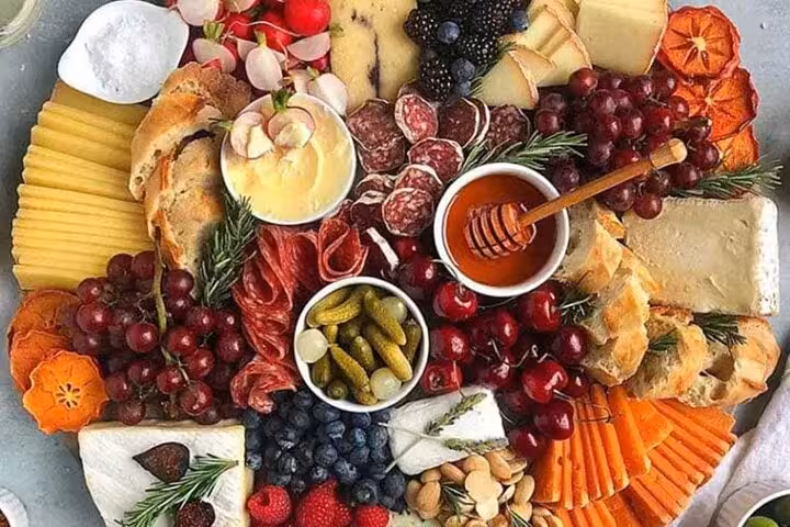 Savor a diverse charcuterie board with cheeses, fruits, and meats on the Discover Paris Flavors tour.