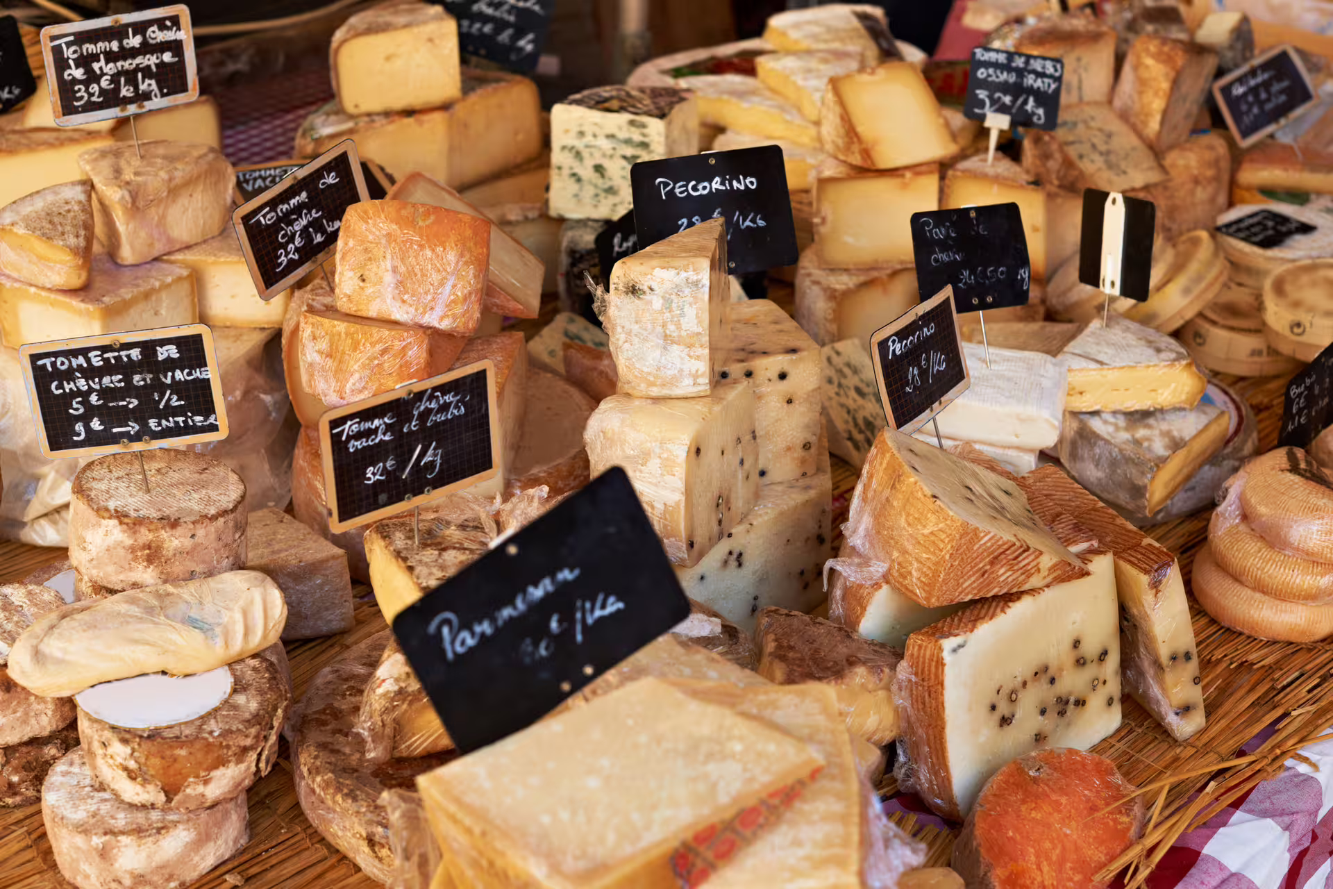 French cheese market stall in Paris, tastings on 1-day foodie walking tour with multilingual audioguide