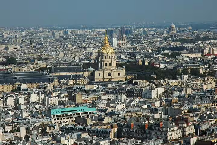 Aerial view of Paris cityscape with the golden dome of Les Invalides seen from the Eiffel Tower summit