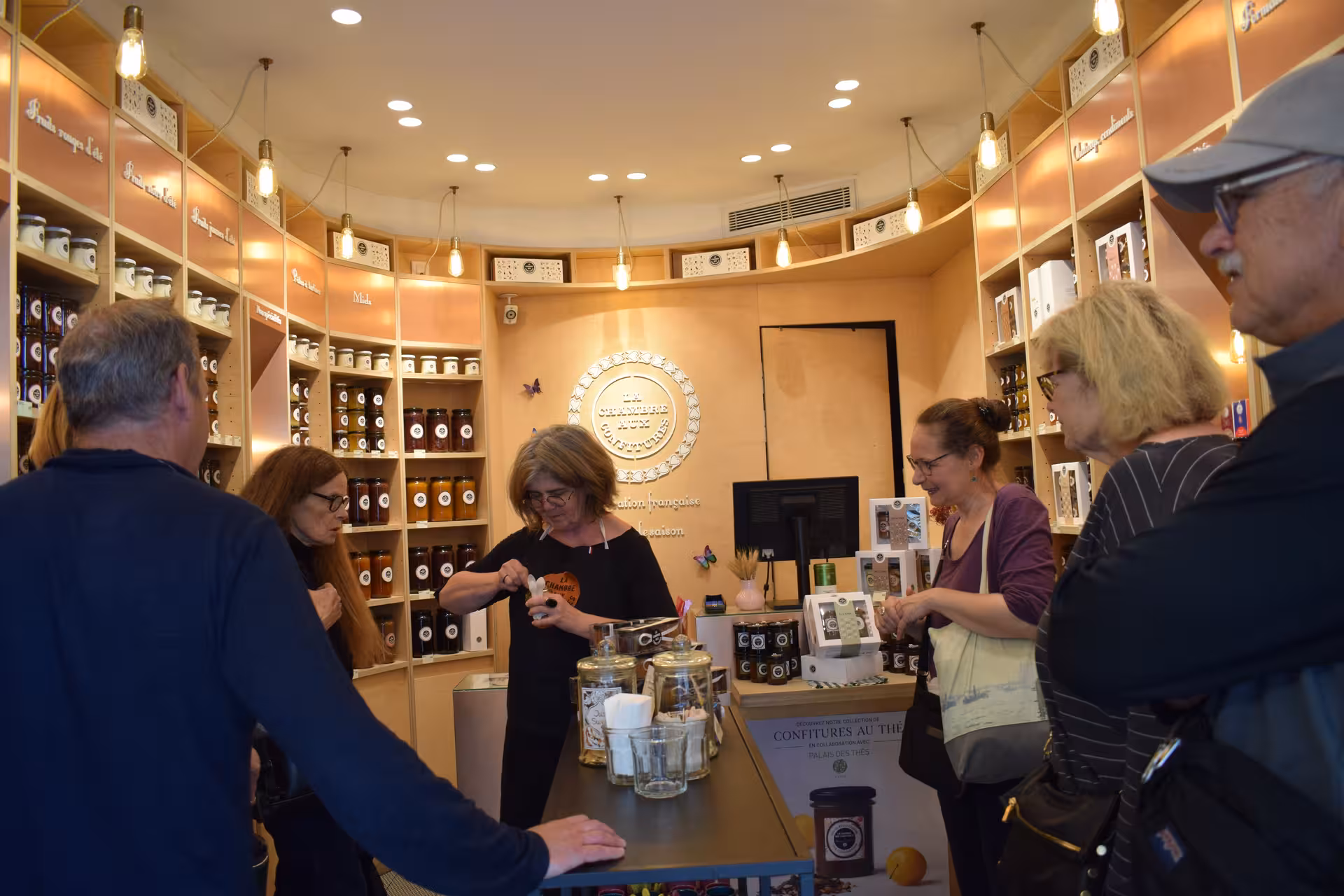 Tourists sampling artisan jams at La Chambre aux Confitures specialty shop in Saint-Germain-des-Pres Paris