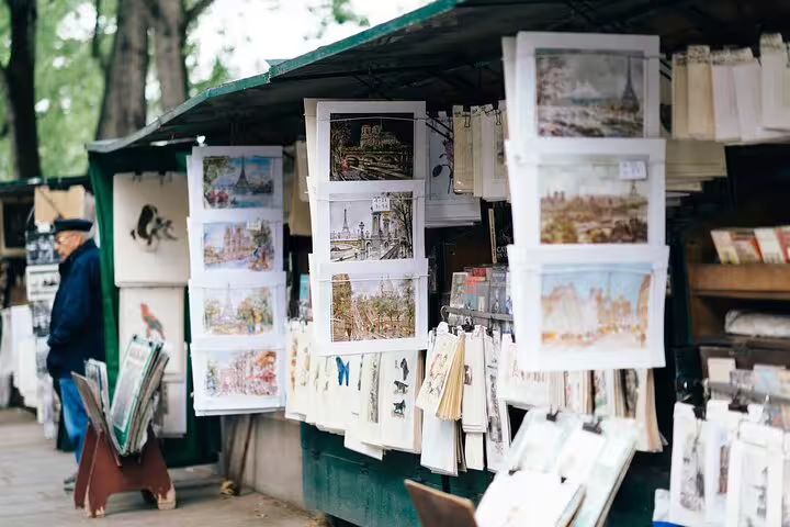 Parisian art prints and postcards displayed at an outdoor bouquiniste stall along the Seine in Paris