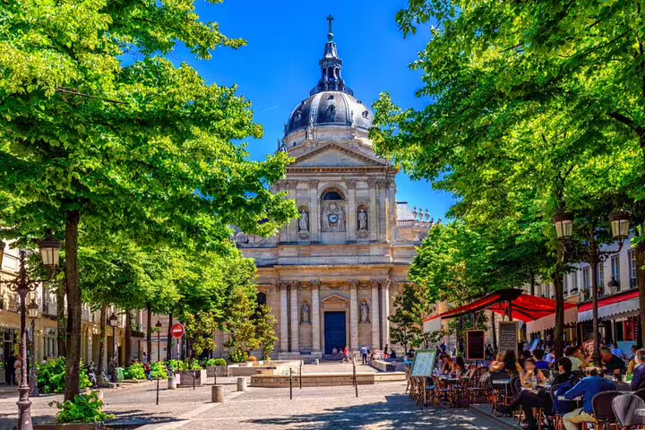 Sorbonne University chapel and tree-lined square with outdoor cafés in Paris Latin Quarter