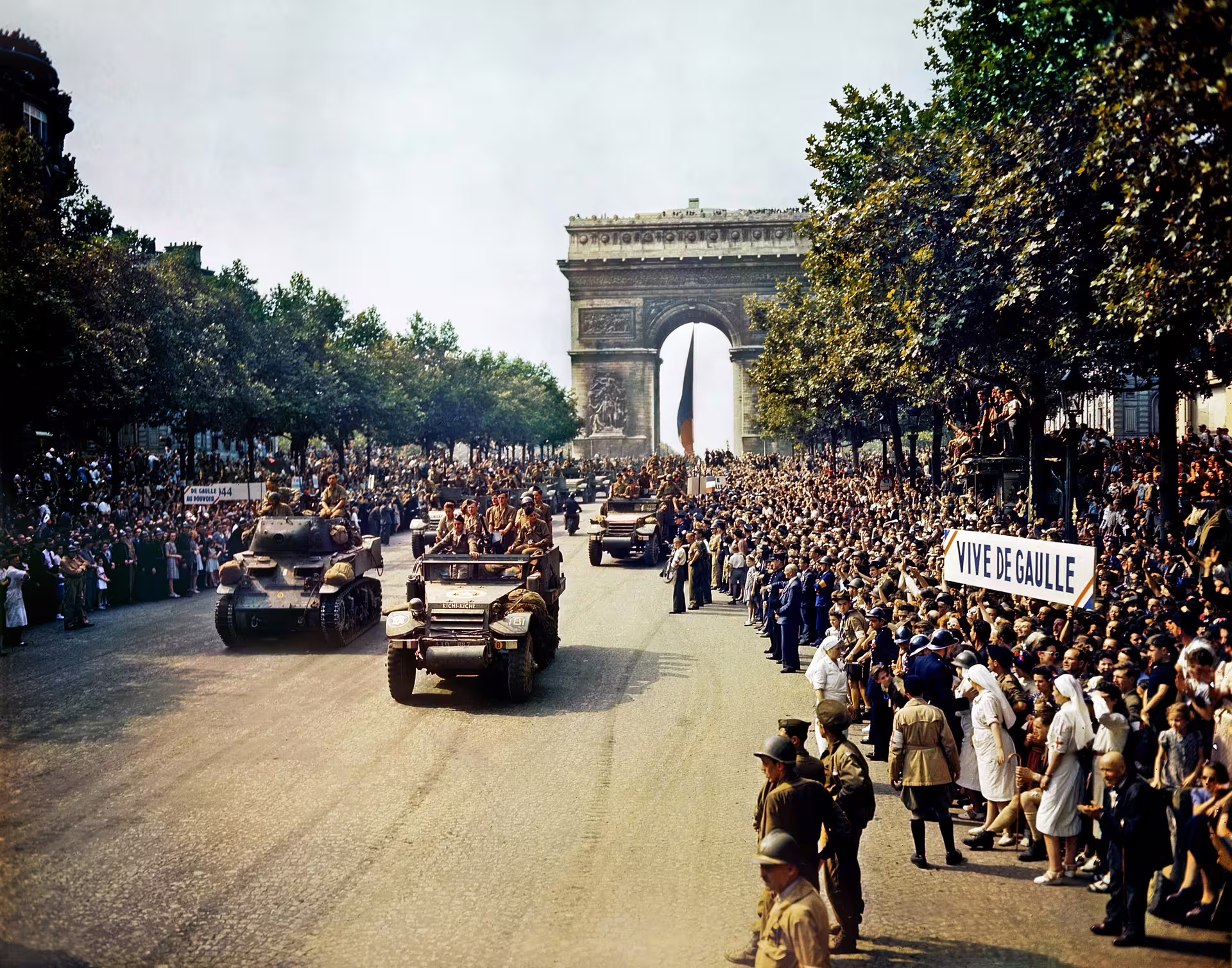 Allied military parade on Champs-Élysées past Arc de Triomphe during Paris Liberation 1944, crowds cheering