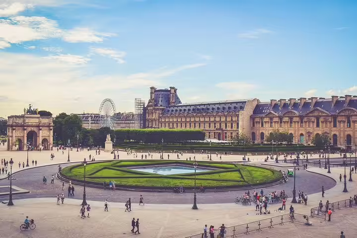 Panoramic view of the Louvre Museum and Tuileries Garden with visitors in Paris