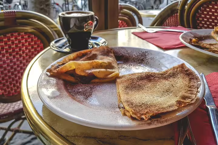 Enjoy delicious French crepes with coffee at a Parisian café, part of the Paris Private Tour with Louvre access.