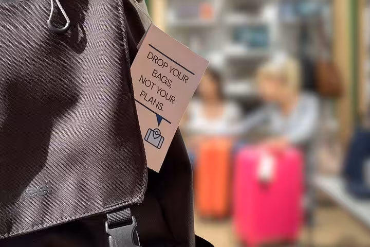 Close-up bag tag saying drop your bags near Gare Saint-Lazare, Paris luggage storage for travelers