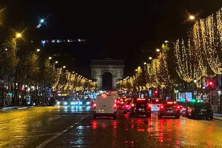 Hop-on Paris city highlights minivan tour on Champs-Élysées at night, Arc de Triomphe and festive lights