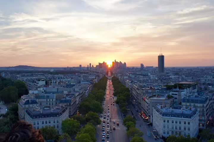 Panoramic aerial view of Paris boulevards at sunset with La Défense skyline in the background