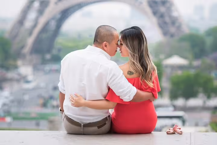 Couple embracing near Eiffel Tower during private Paris photoshoot session