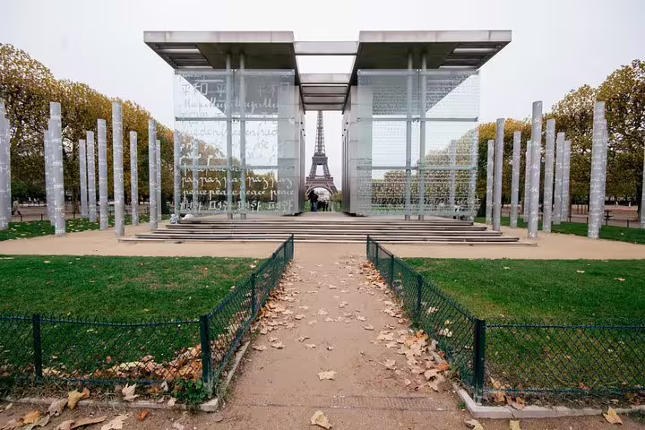 Pathway leading to the Wall for Peace with the Eiffel Tower in the background, showcasing iconic Parisian landmarks for a private city tour.
